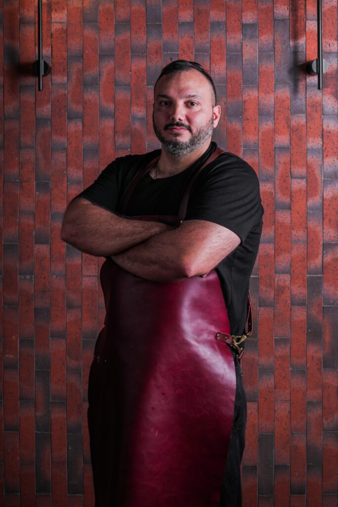 Portrait image of Chef Miguel Gallo. He is the head Chef at Fireside, an open-fire restaurant. 