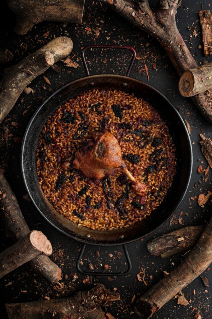 An image of Fireside's signature dish, the duck confit rice with morel mushroom. Cooked using the open-fire method. 