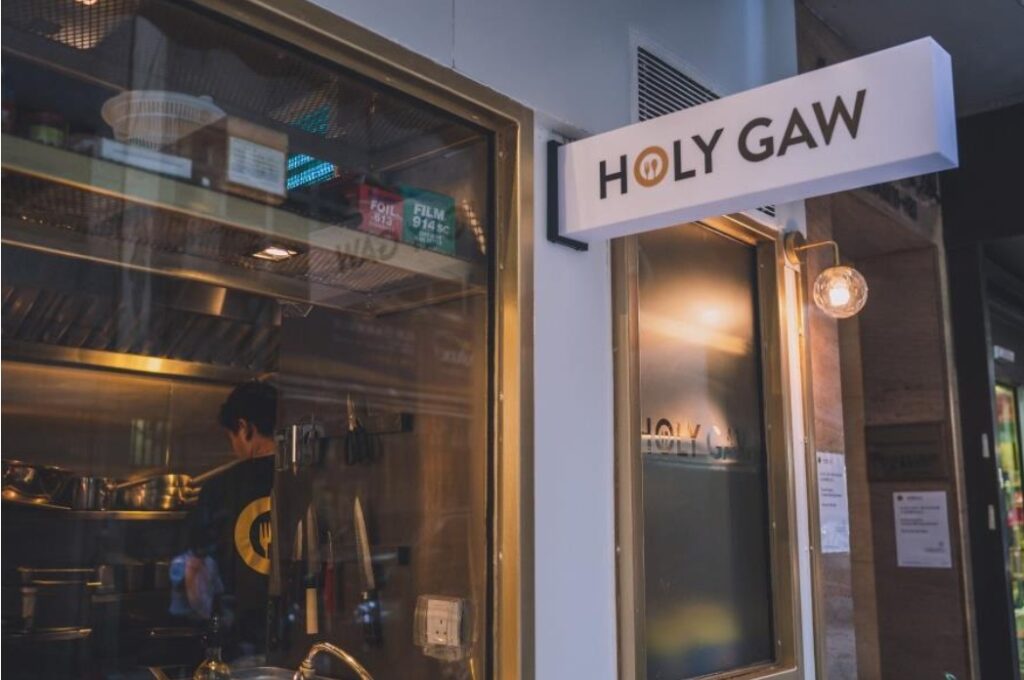 An image of a signage reading "Holy Gaw". 